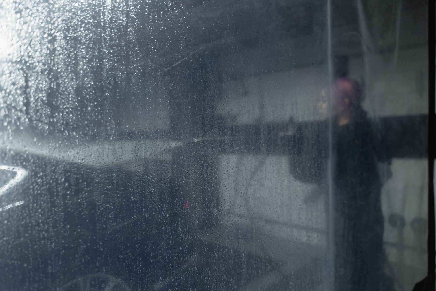 Inside a wash bay, floor still wet