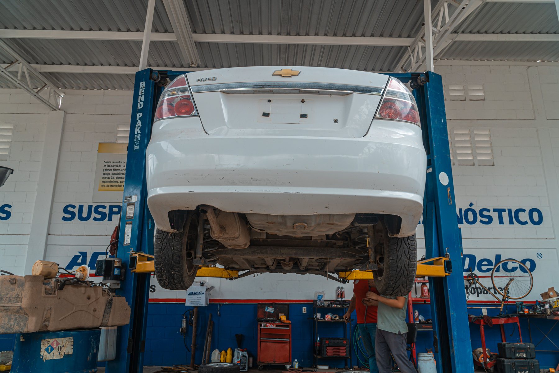 A car raised on a lift for diagnosis