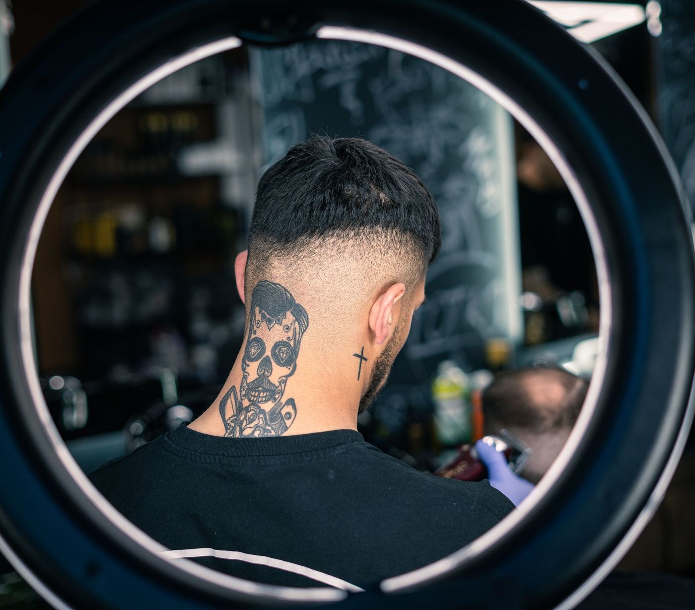 A textured crop and skin fade seen through a ring light