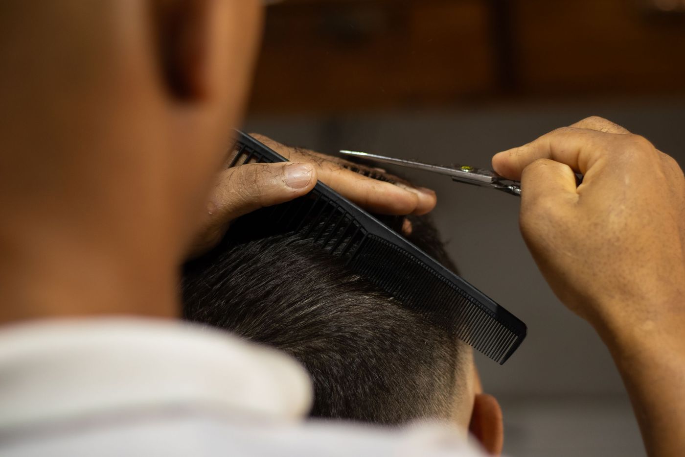 Scissor-over-comb on the crown, from over the barber’s shoulder