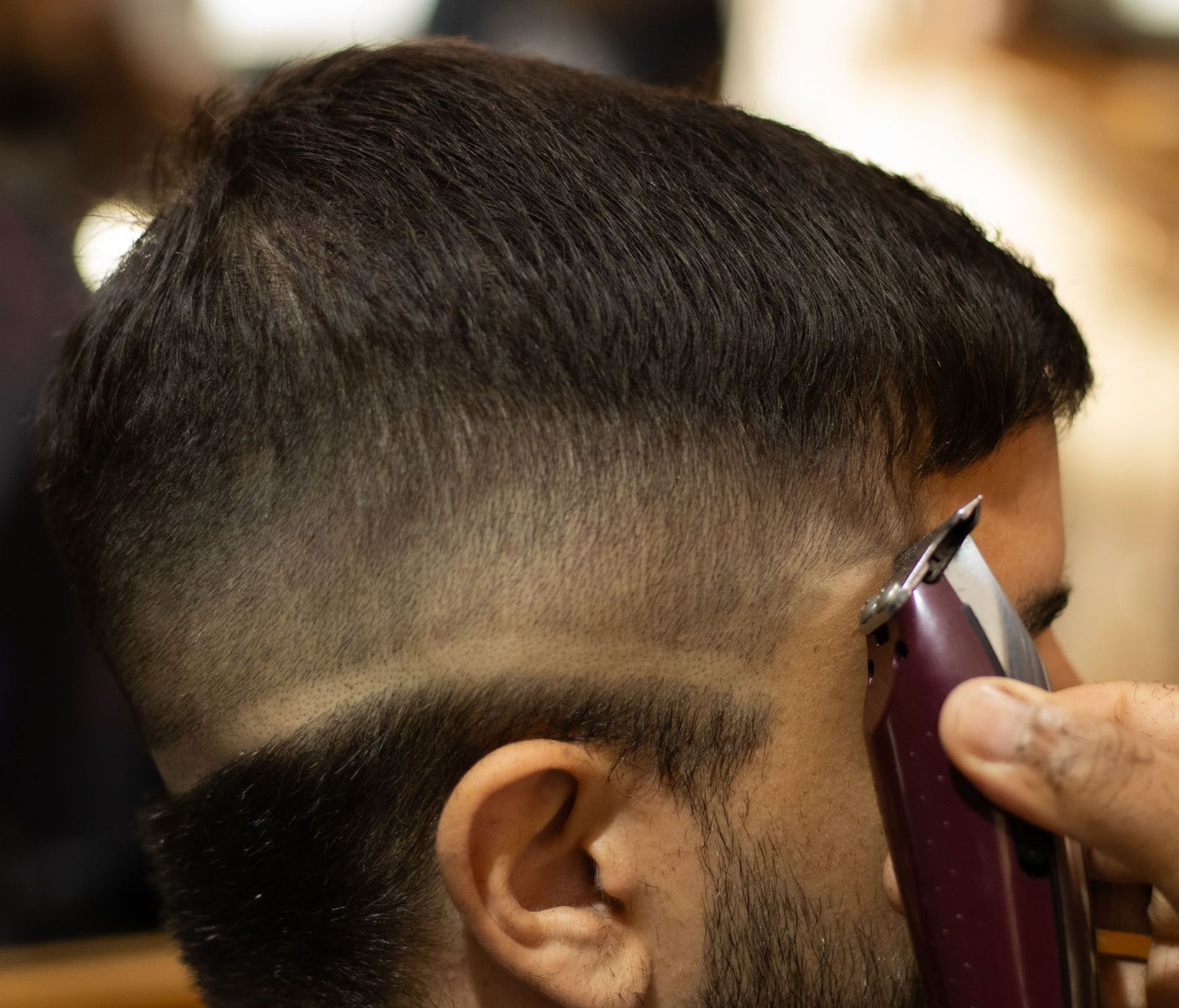A mid fade blended from skin at the ear up into length on top