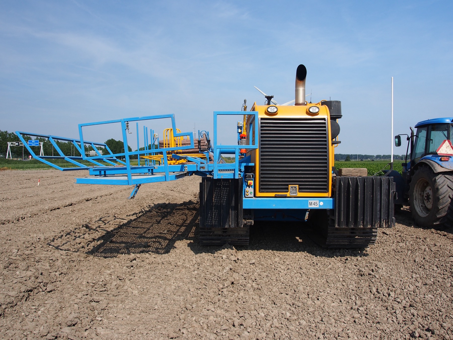 A tracked drainage machine on a field job