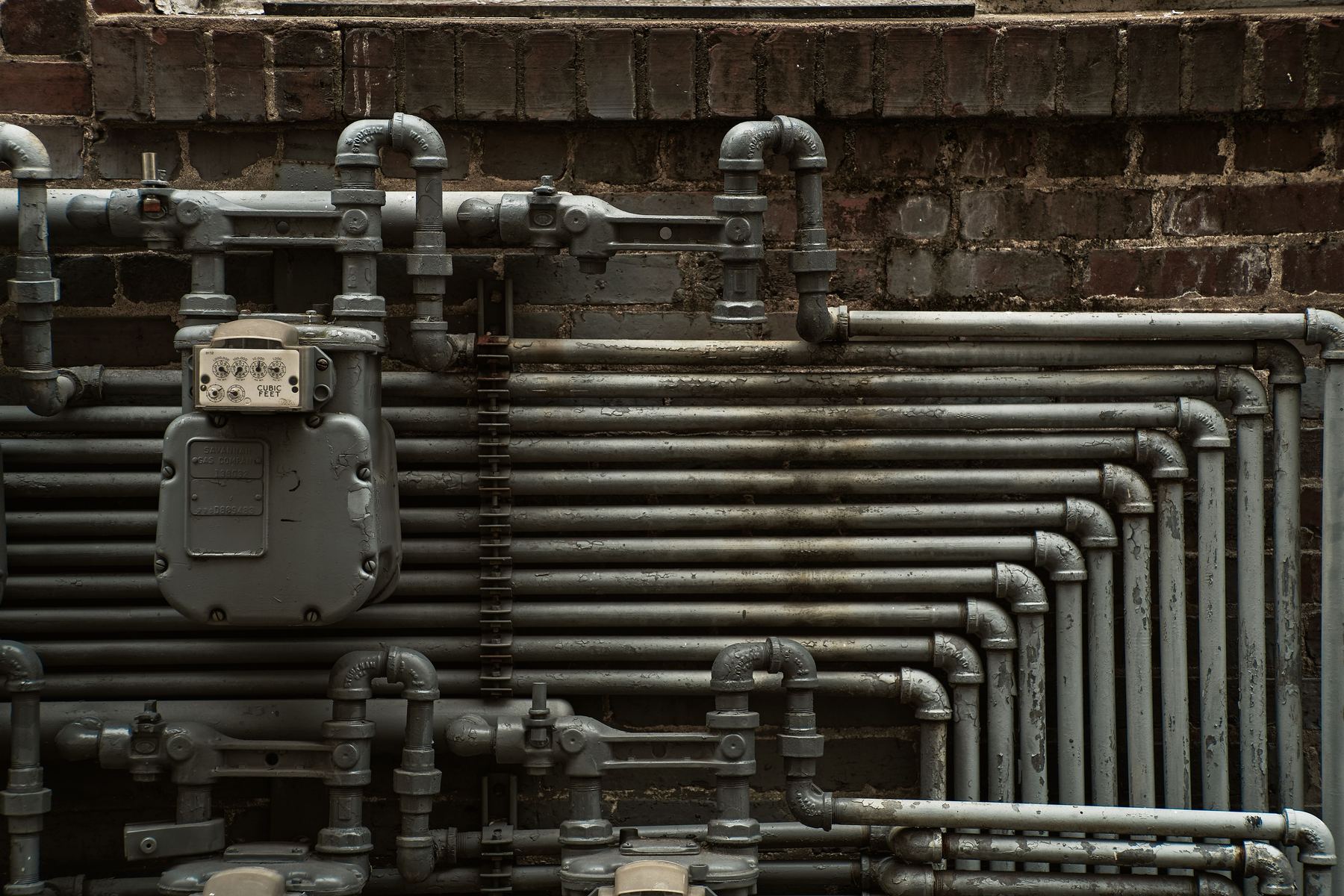 A cast grate with SEWER raised in the iron