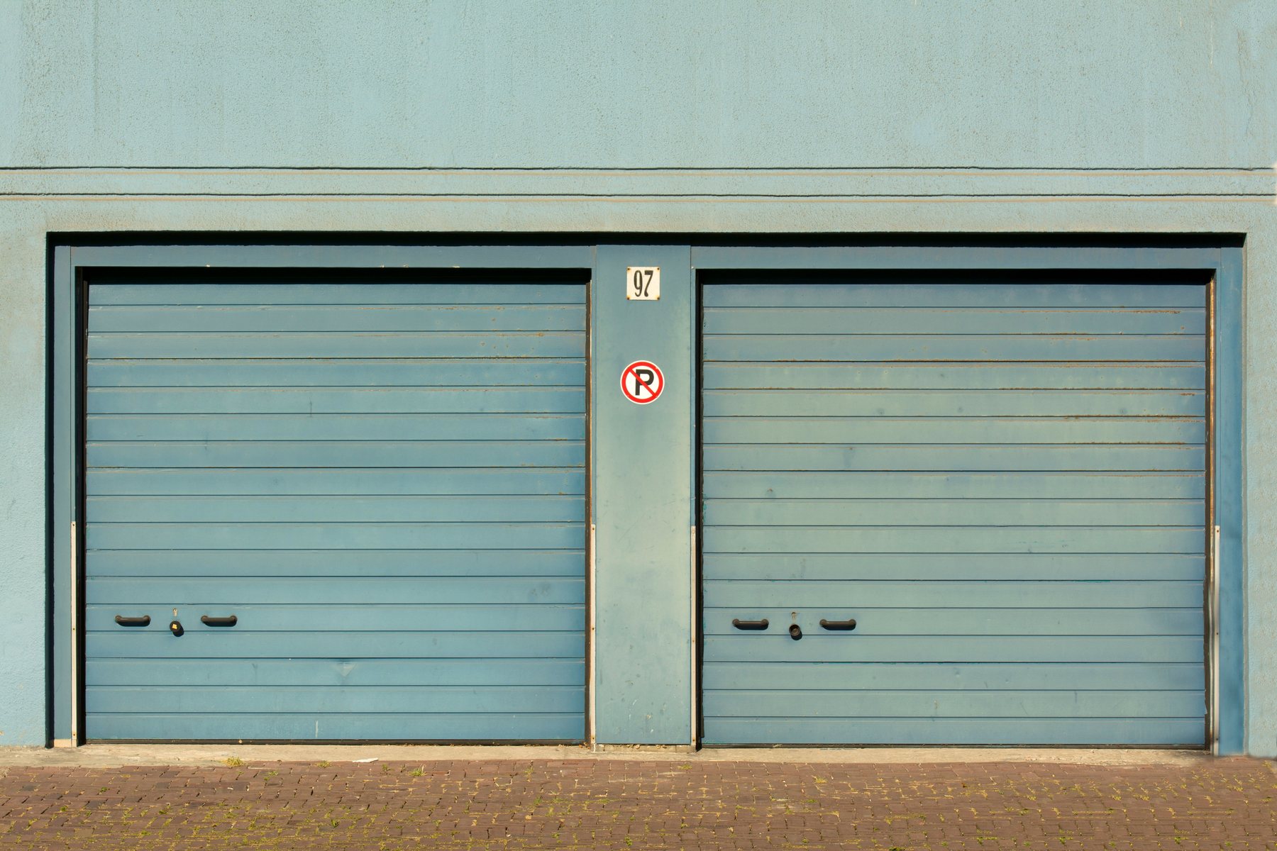 Looking up at the spring and track assembly above a garage door
