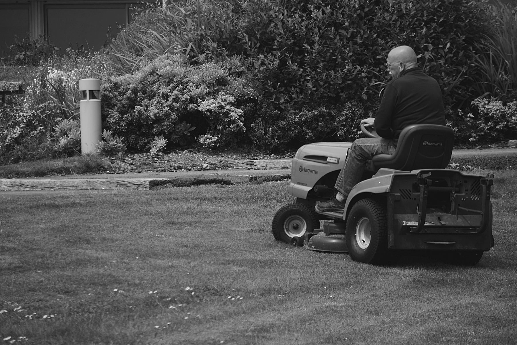 Cutting a lawn with a riding mower