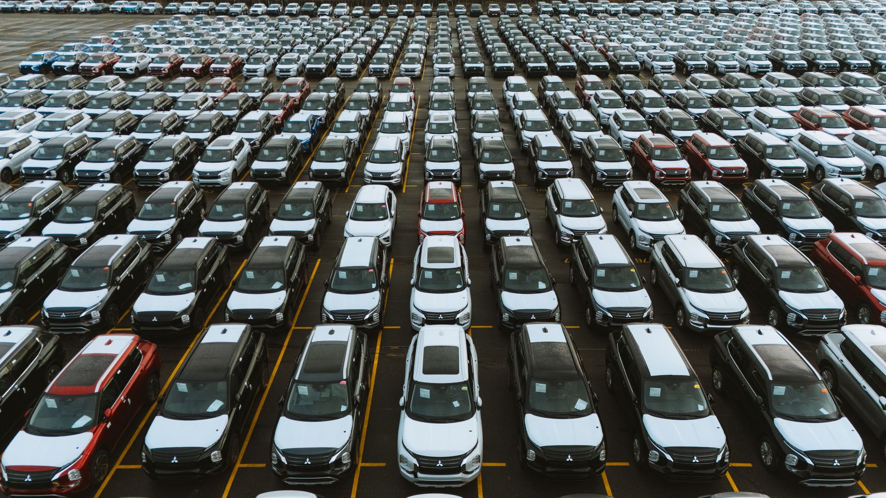 A fleet of identical vehicles lined up in a yard