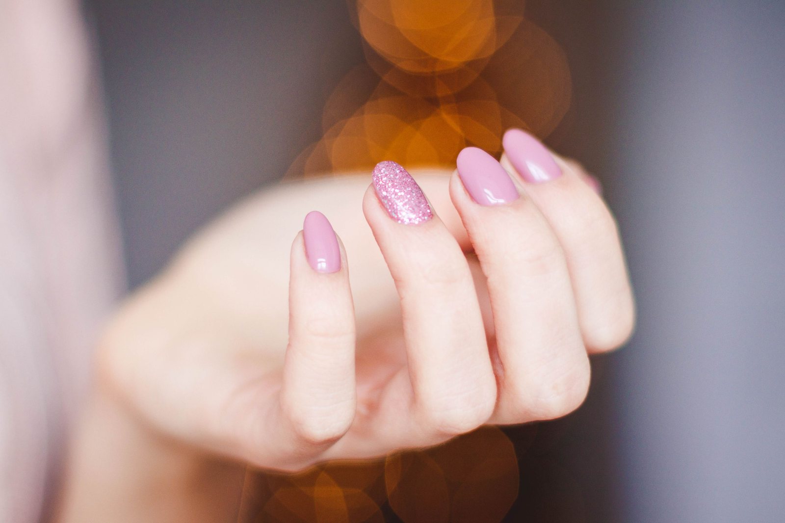 Soft pink almond nails with one pink glitter accent nail