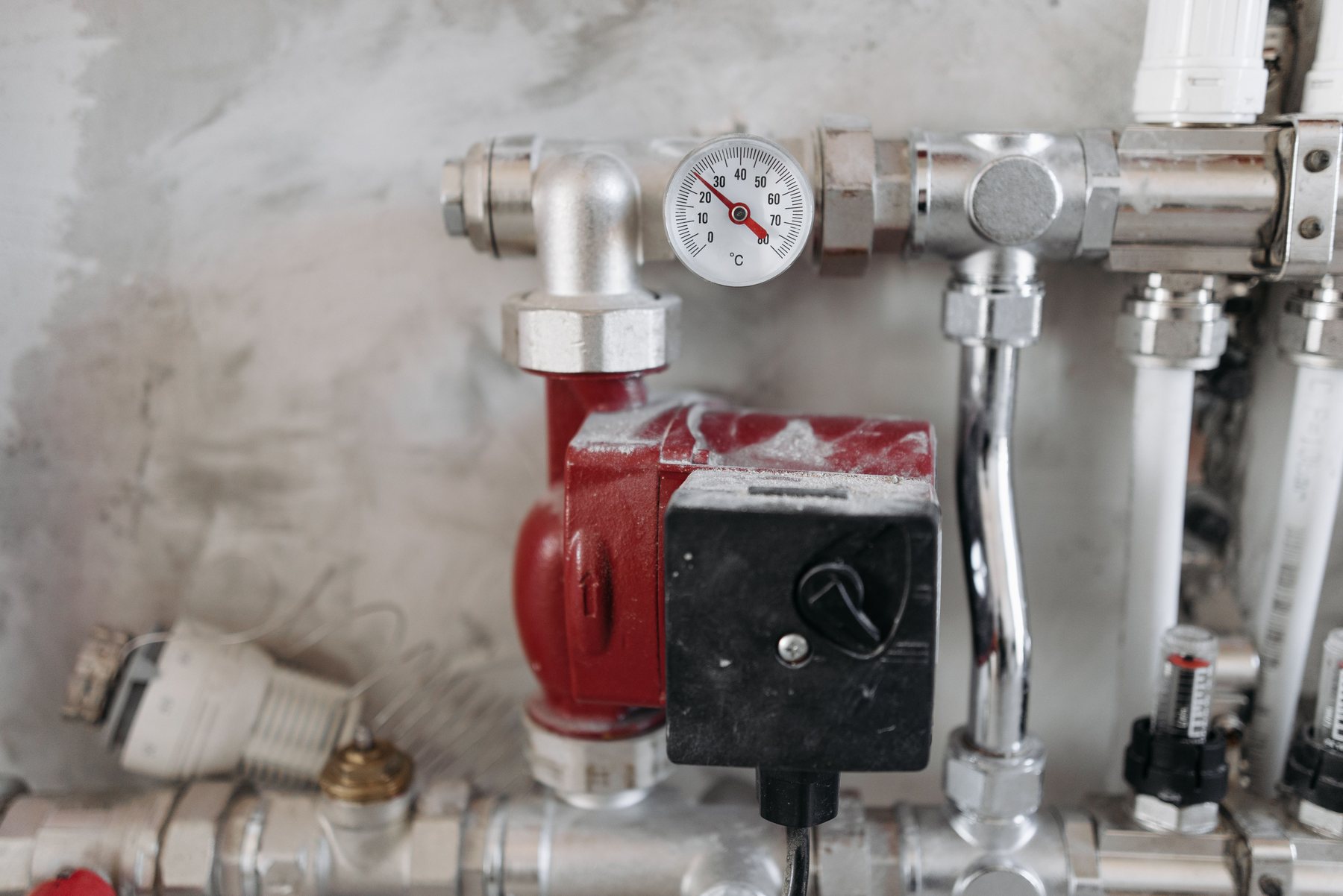 Copper pipework and heating manifold on a wall