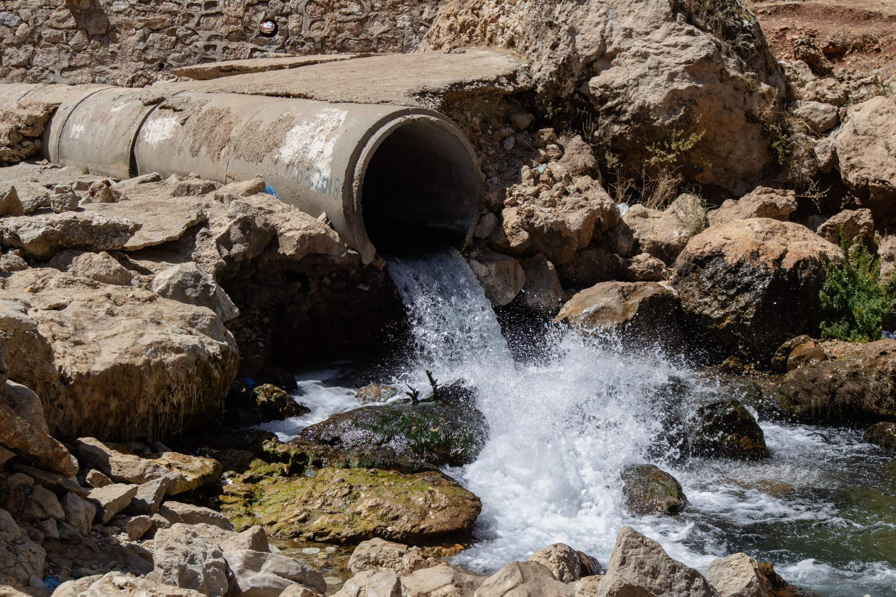 Water escaping from a buried pipe at the surface