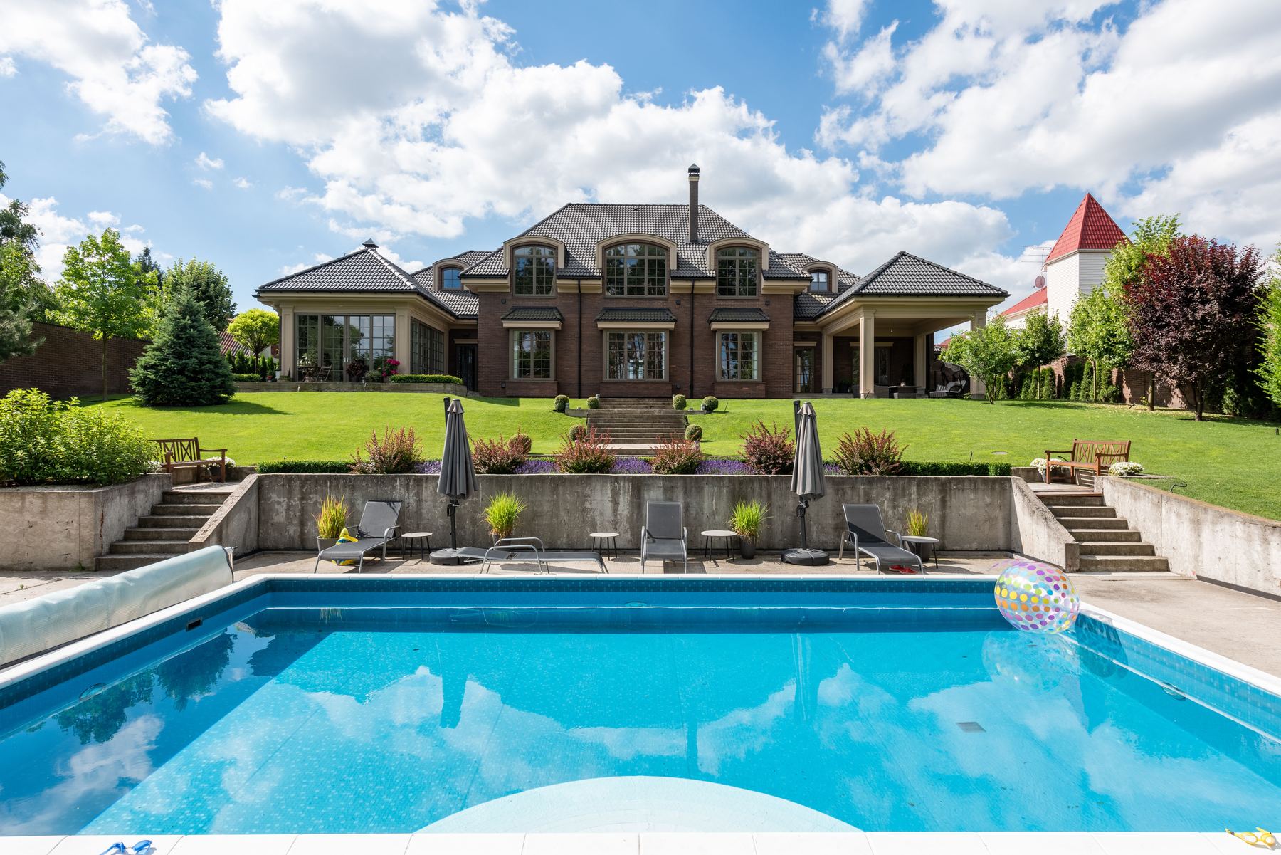 A backyard swimming pool behind a house