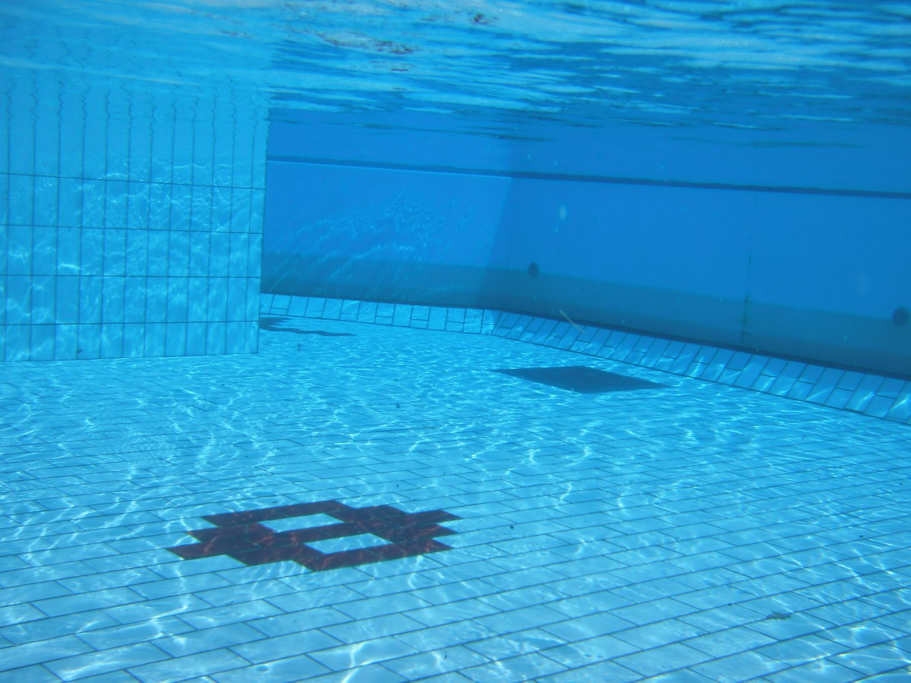 Looking through clear pool water to the floor