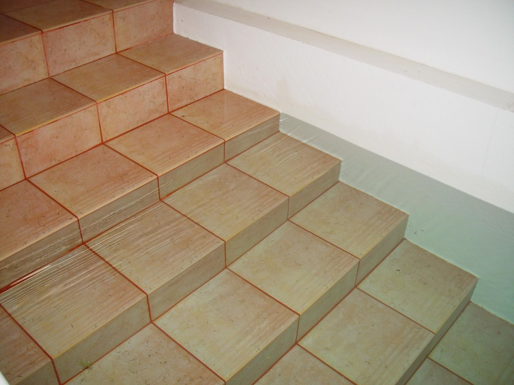 Water rippling over the tiled steps of a pool