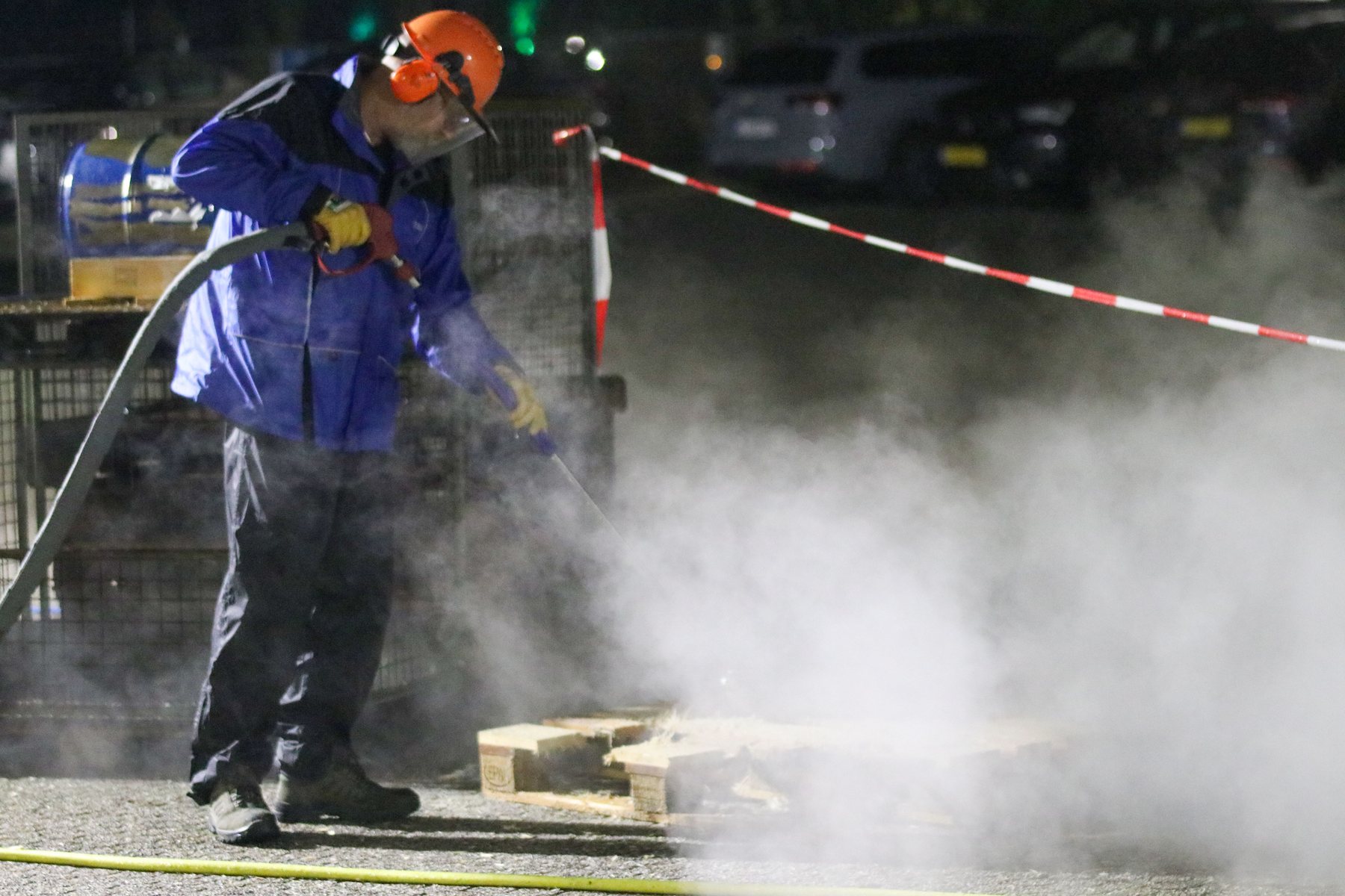 A pressure washer at work, steam coming off the surface