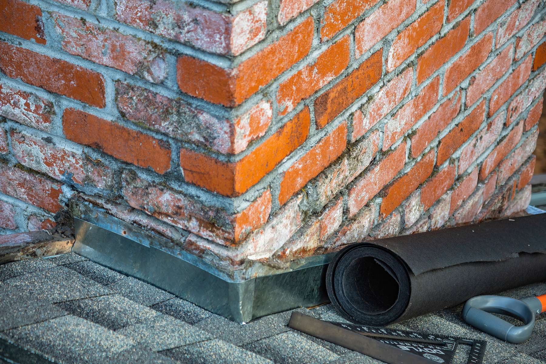 Lead flashing dressed in around a chimney stack
