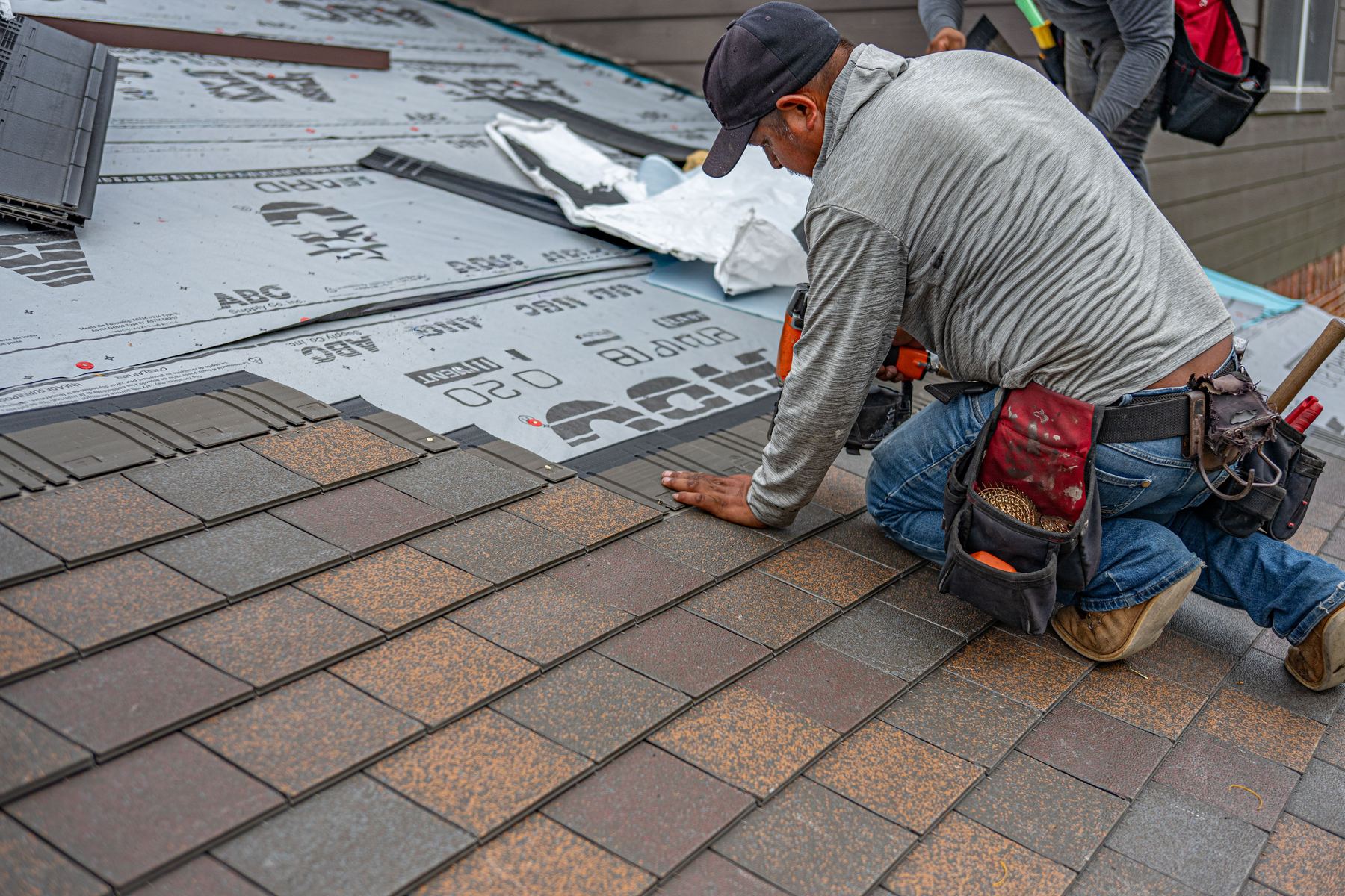Asphalt shingles lifted and failing, the path a leak takes