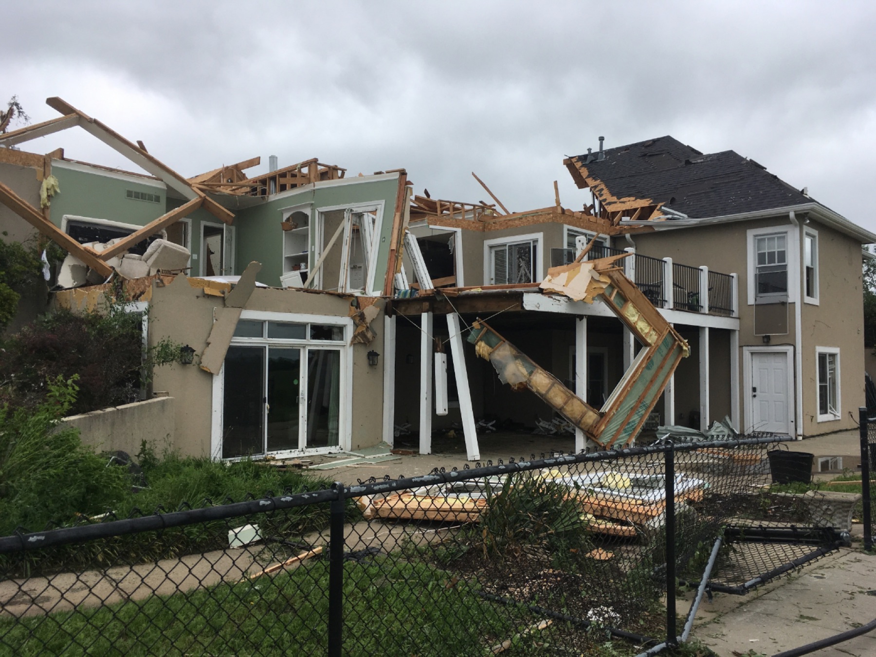 A house with its roof torn open by storm damage