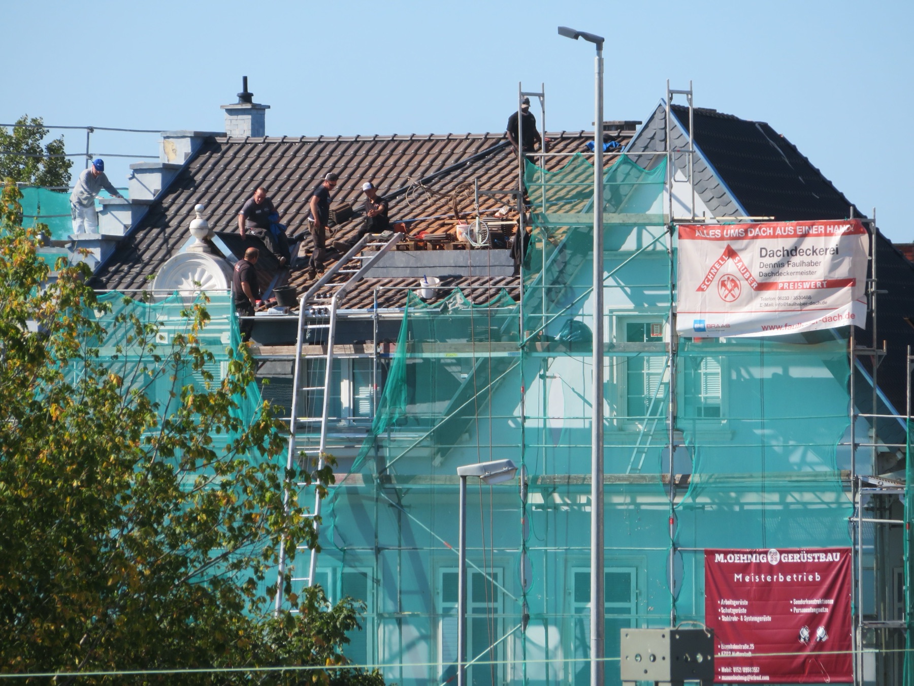 A tear-off in progress: old shingles stripped back to the deck