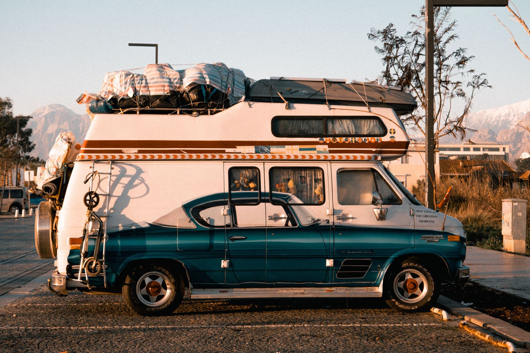 A camper van parked at sunset