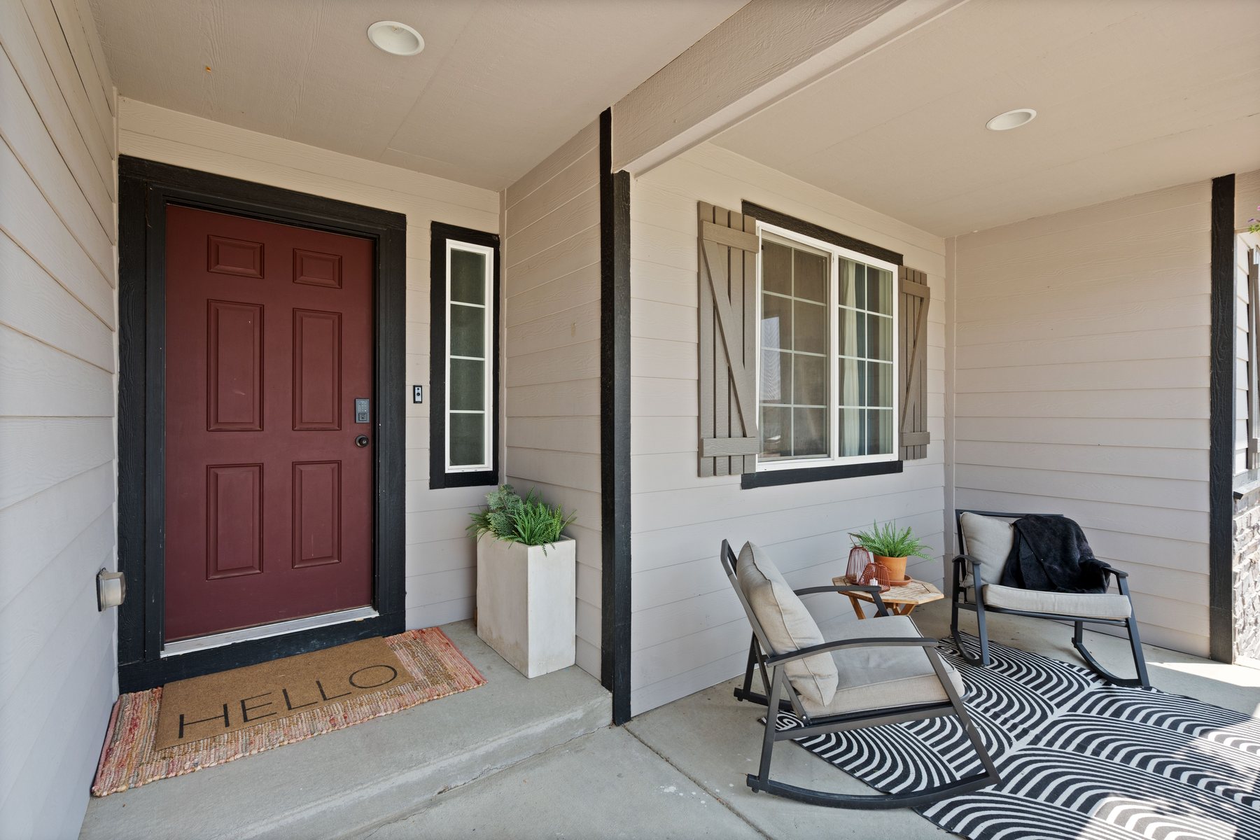 A screened porch with chairs set out along it